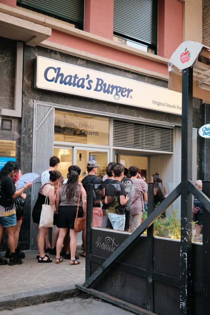 Entrada a la hamburgueseria chatas burguer el día de la innaguración. Se ve una cola de personas esperando a entrar