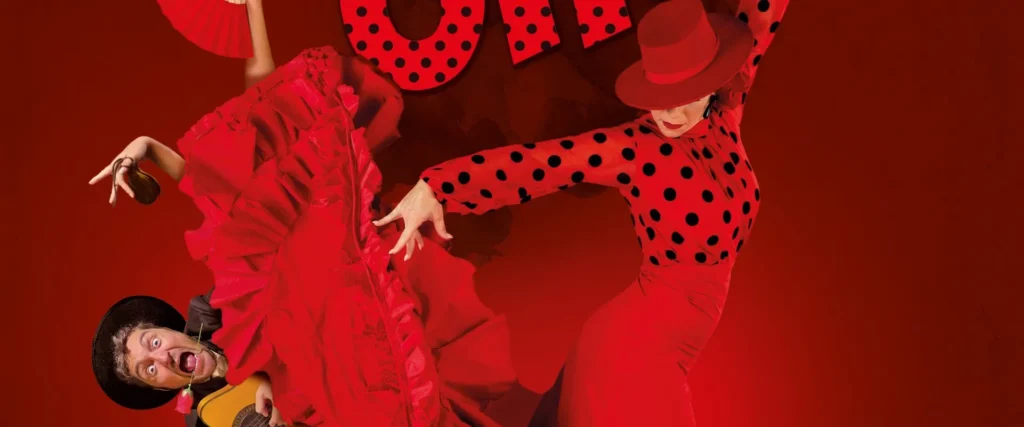 Dos personas hombre y mujer bailando flamenco, parece que el hombre está cayéndose.