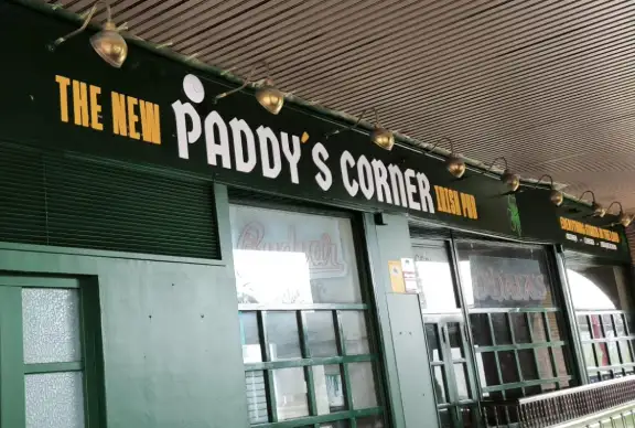 Entrada al establecimiento, estilo irlandes con grandes ventanales y letras en blanco y amarillo sobre la fachada verde