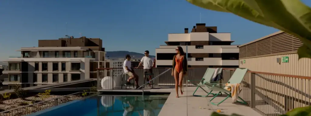 azotea con piscina y personas en la terraza, mujer caminando con bañador naranja