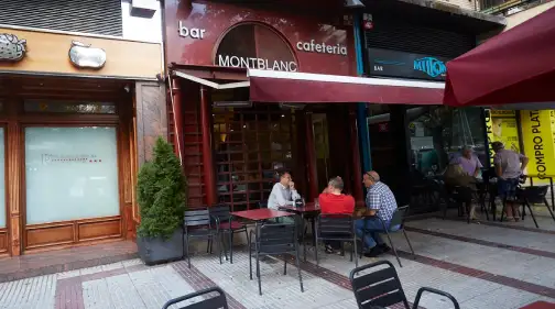 Facha del establecimiento en color granate, con terraza en el exterior