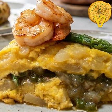 Tortilla de patata rellena de espárragos trigueros y gambas al ajillo