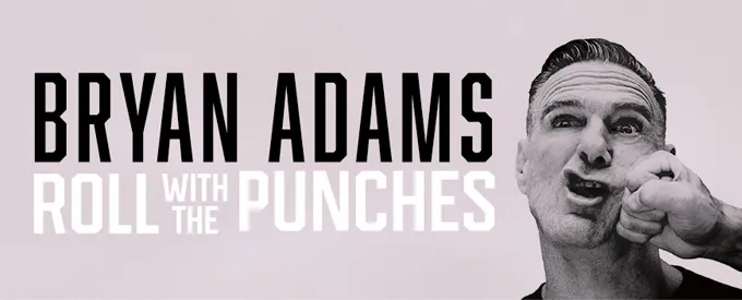 Cartel promocional de Bryan Adams con el texto “Roll with the Punches”. A la derecha, imagen en blanco y negro del cantante recibiendo un puñetazo en la cara.